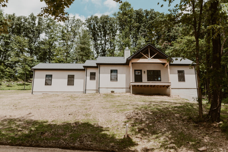 Portfolio Image - Modern farmhouse ranch on a secluded wooded hillside lot